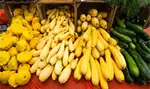Yellow and green produce on a red table